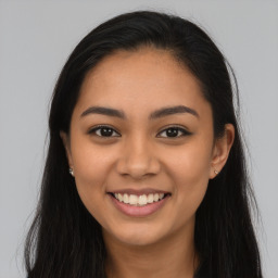 Joyful latino young-adult female with long  brown hair and brown eyes