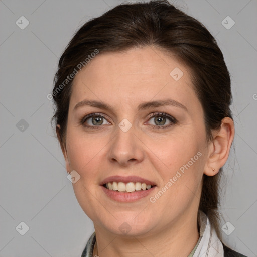 Joyful white adult female with medium  brown hair and brown eyes