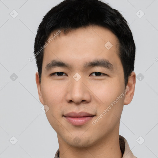 Joyful asian young-adult male with short  black hair and brown eyes