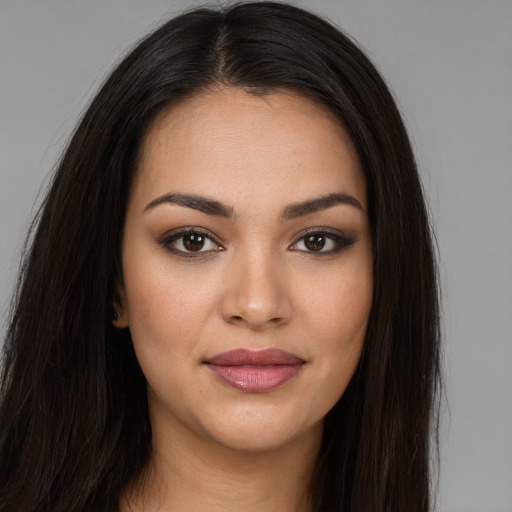 Joyful latino young-adult female with long  brown hair and brown eyes