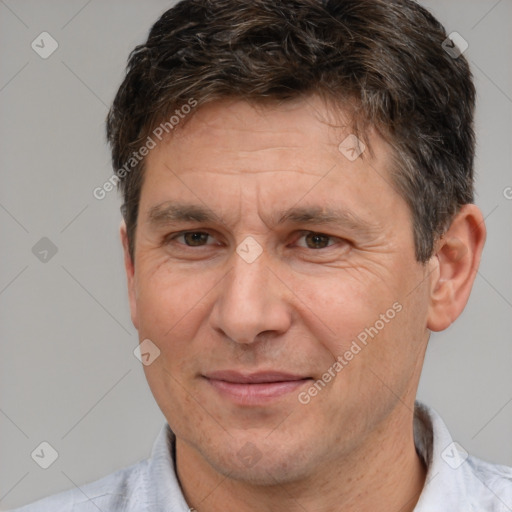 Joyful white adult male with short  brown hair and brown eyes