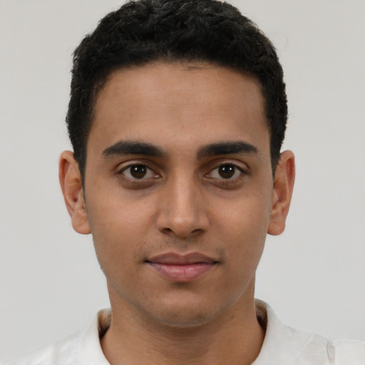 Joyful latino young-adult male with short  brown hair and brown eyes