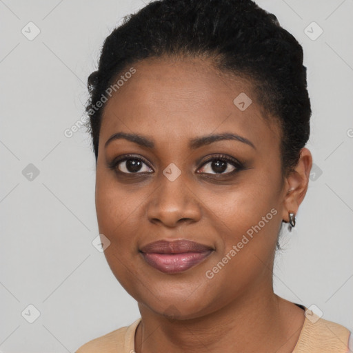 Joyful black young-adult female with short  black hair and brown eyes