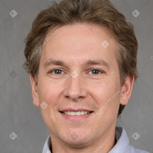 Joyful white adult male with short  brown hair and grey eyes