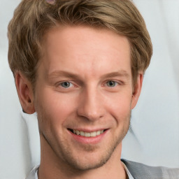 Joyful white young-adult male with short  brown hair and blue eyes