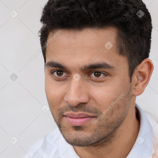 Joyful white young-adult male with short  black hair and brown eyes