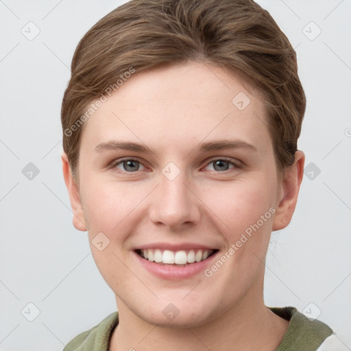 Joyful white young-adult female with short  brown hair and grey eyes