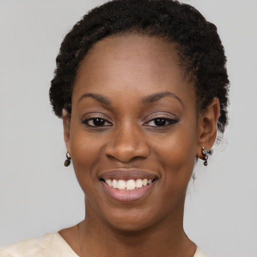 Joyful black young-adult female with short  black hair and brown eyes