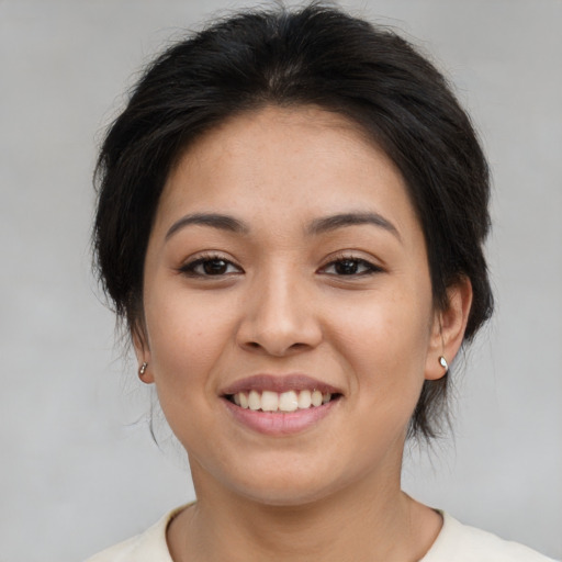 Joyful asian young-adult female with medium  brown hair and brown eyes