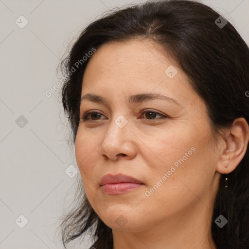 Joyful white adult female with long  brown hair and brown eyes