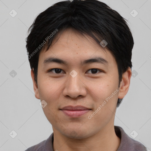 Joyful asian young-adult male with short  brown hair and brown eyes