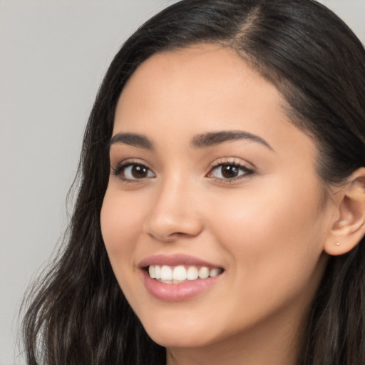 Joyful latino young-adult female with long  brown hair and brown eyes