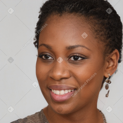 Joyful black young-adult female with short  brown hair and brown eyes