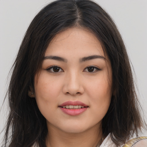 Joyful white young-adult female with long  brown hair and brown eyes