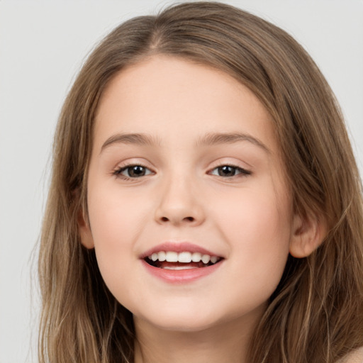 Joyful white child female with long  brown hair and brown eyes