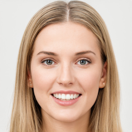 Joyful white young-adult female with long  brown hair and green eyes