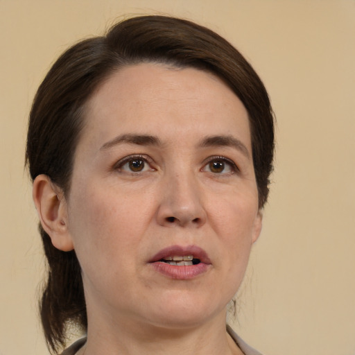 Joyful white adult female with medium  brown hair and brown eyes