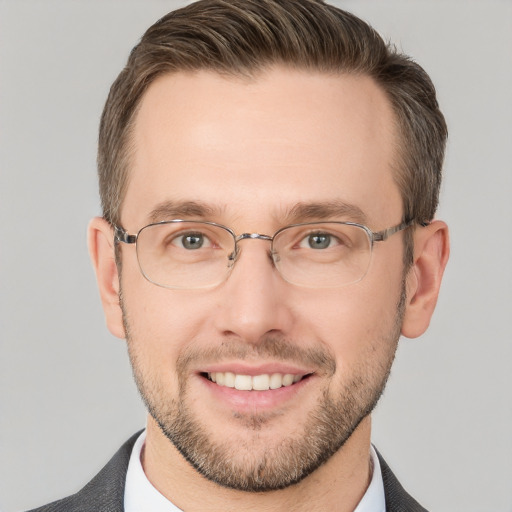 Joyful white adult male with short  brown hair and grey eyes