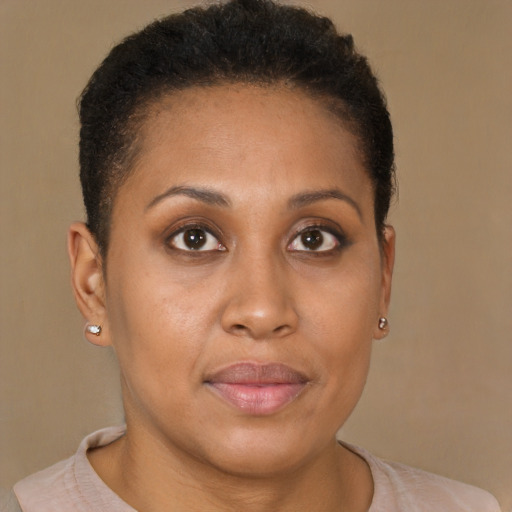 Joyful black young-adult female with short  brown hair and brown eyes