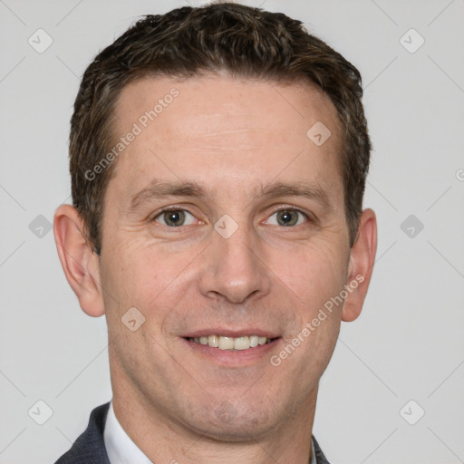 Joyful white adult male with short  brown hair and grey eyes