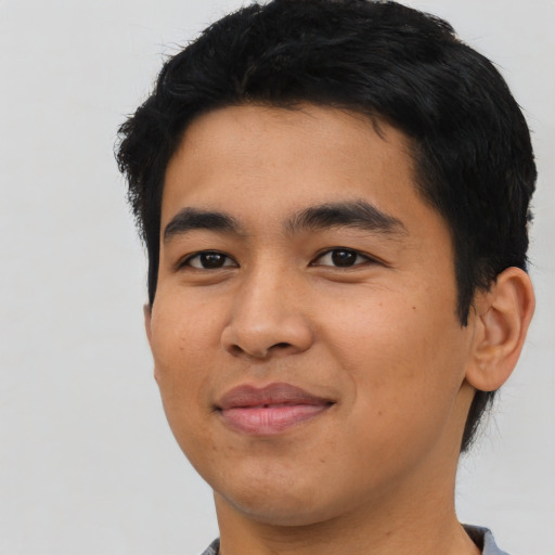 Joyful asian young-adult male with short  black hair and brown eyes