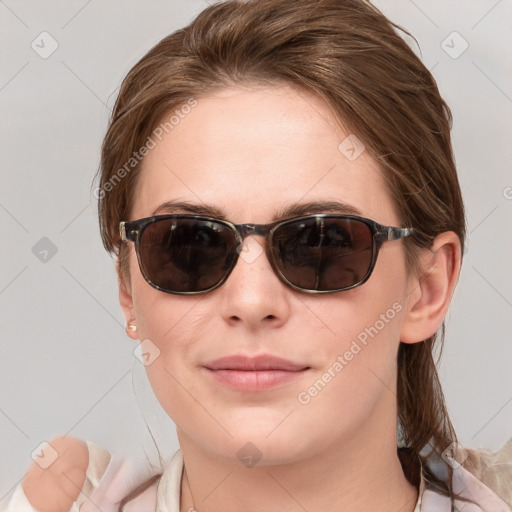 Joyful white young-adult female with medium  brown hair and blue eyes