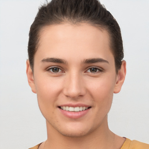 Joyful white young-adult female with short  brown hair and brown eyes