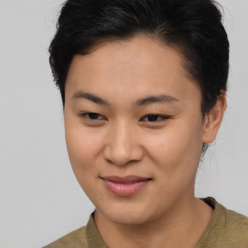Joyful asian young-adult female with short  brown hair and brown eyes