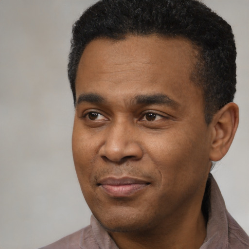Joyful latino adult male with short  black hair and brown eyes