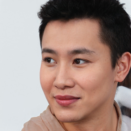 Joyful asian young-adult male with short  brown hair and brown eyes