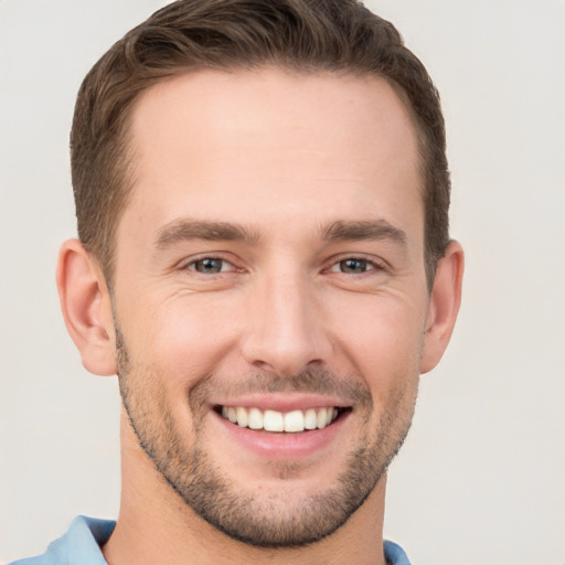 Joyful white young-adult male with short  brown hair and brown eyes