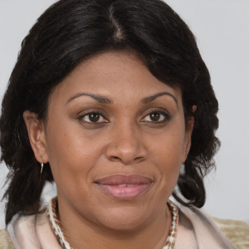 Joyful white adult female with medium  brown hair and brown eyes
