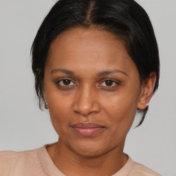 Joyful asian adult female with medium  brown hair and brown eyes