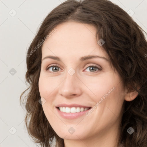 Joyful white young-adult female with long  brown hair and green eyes