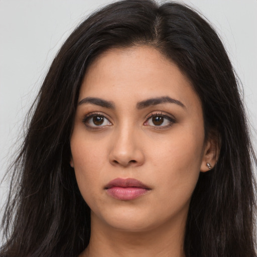 Neutral latino young-adult female with long  brown hair and brown eyes