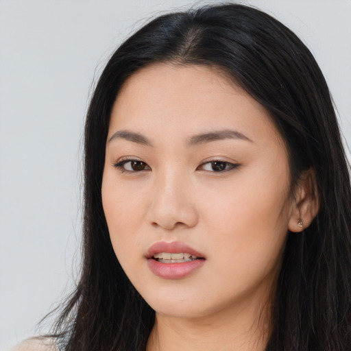 Joyful asian young-adult female with long  black hair and brown eyes