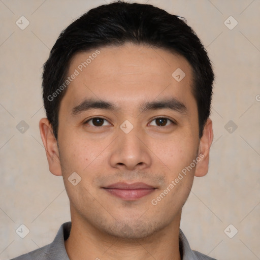 Joyful asian young-adult male with short  black hair and brown eyes