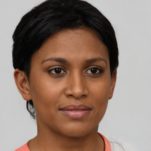 Joyful black young-adult female with short  brown hair and brown eyes
