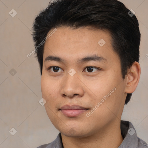 Joyful asian young-adult male with short  black hair and brown eyes