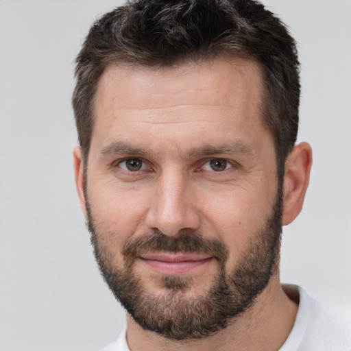 Joyful white adult male with short  brown hair and brown eyes