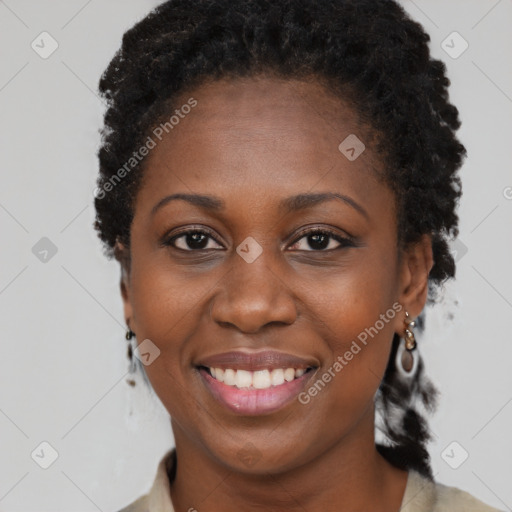 Joyful black young-adult female with short  black hair and brown eyes