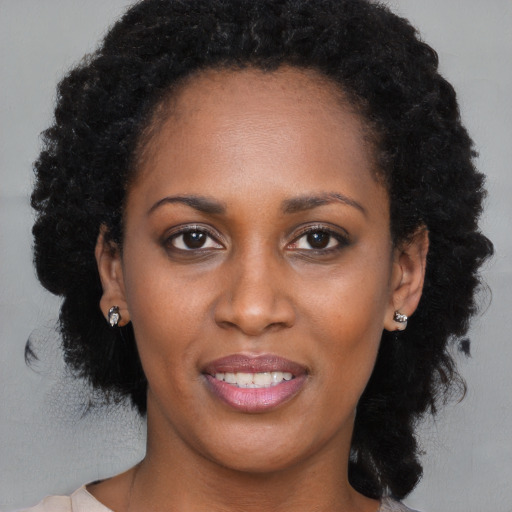 Joyful black young-adult female with medium  brown hair and brown eyes