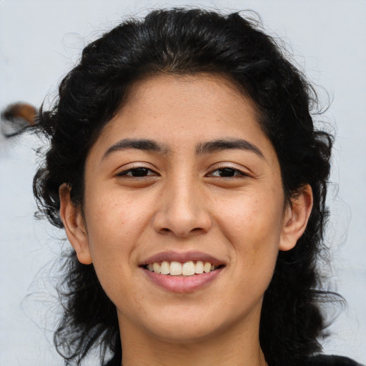 Joyful asian young-adult female with long  brown hair and brown eyes
