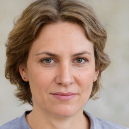 Joyful white adult female with medium  brown hair and blue eyes