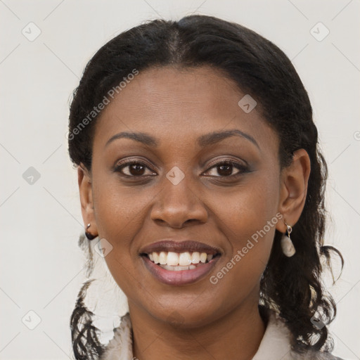 Joyful black young-adult female with long  brown hair and brown eyes