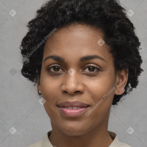 Joyful black young-adult female with short  black hair and brown eyes