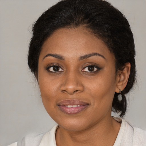 Joyful black young-adult female with medium  brown hair and brown eyes