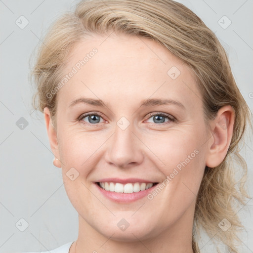 Joyful white young-adult female with medium  brown hair and blue eyes