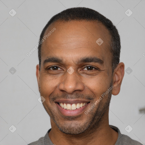 Joyful latino adult male with short  black hair and brown eyes