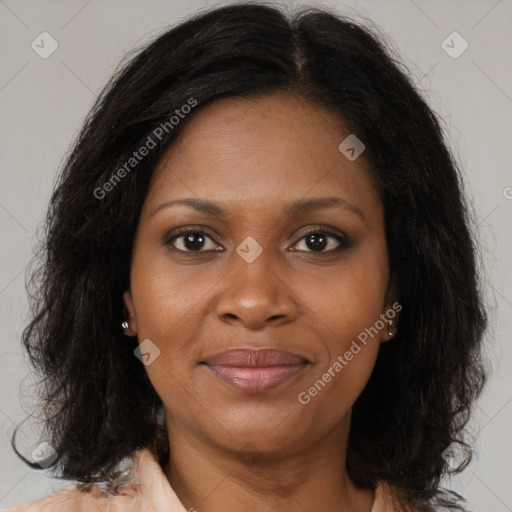 Joyful black adult female with medium  brown hair and brown eyes